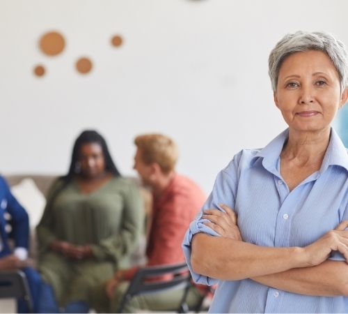 Woman standing in front of a support group